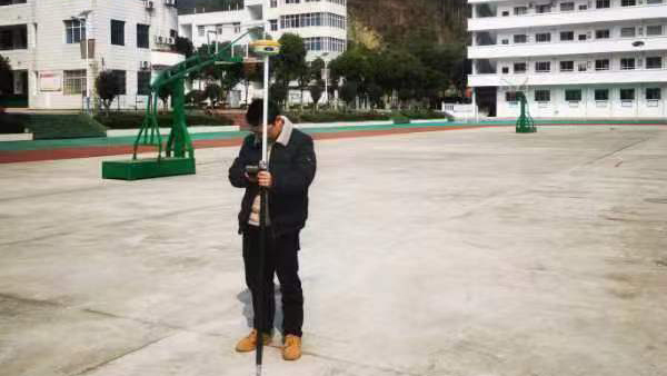 3.1工程勘测部测量人员在磨市镇救师口初级中学进行运动场改扩建项目现场测量